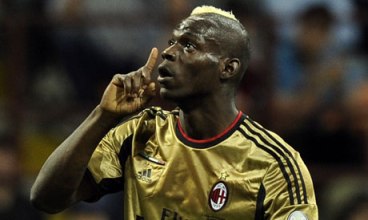 Mario Balotelli tries to quiet racist chants from the Roma Ultras Sunday.
